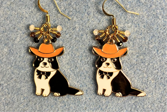 Black and white enamel cat charm earrings adorned with tiny dangling black, orange, and white Chinese crystal beads.