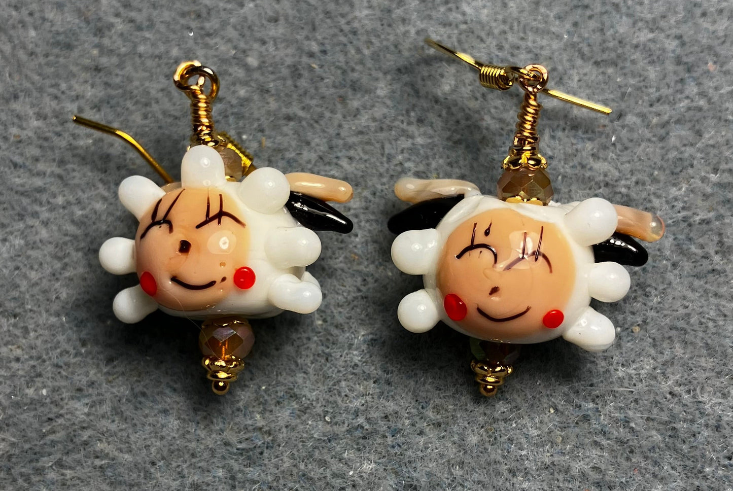 White, beige, and red lamp work sheep bead earrings adorned with beige Chinese crystal beads.