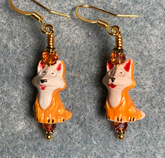 Small orange and white ceramic fox bead earrings adorned orange Chinese crystal beads.