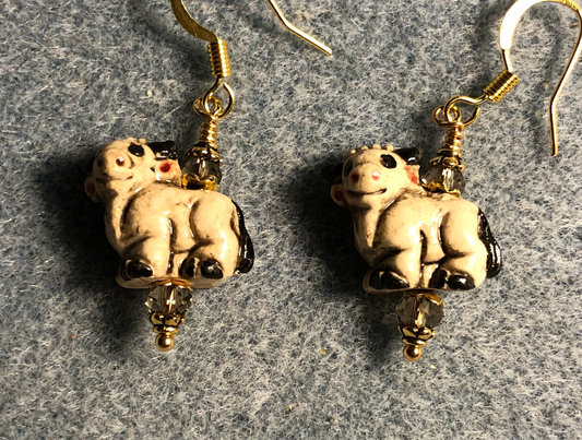 Small tan and black ceramic ram bead earrings adorned with tan Chinese crystal beads.