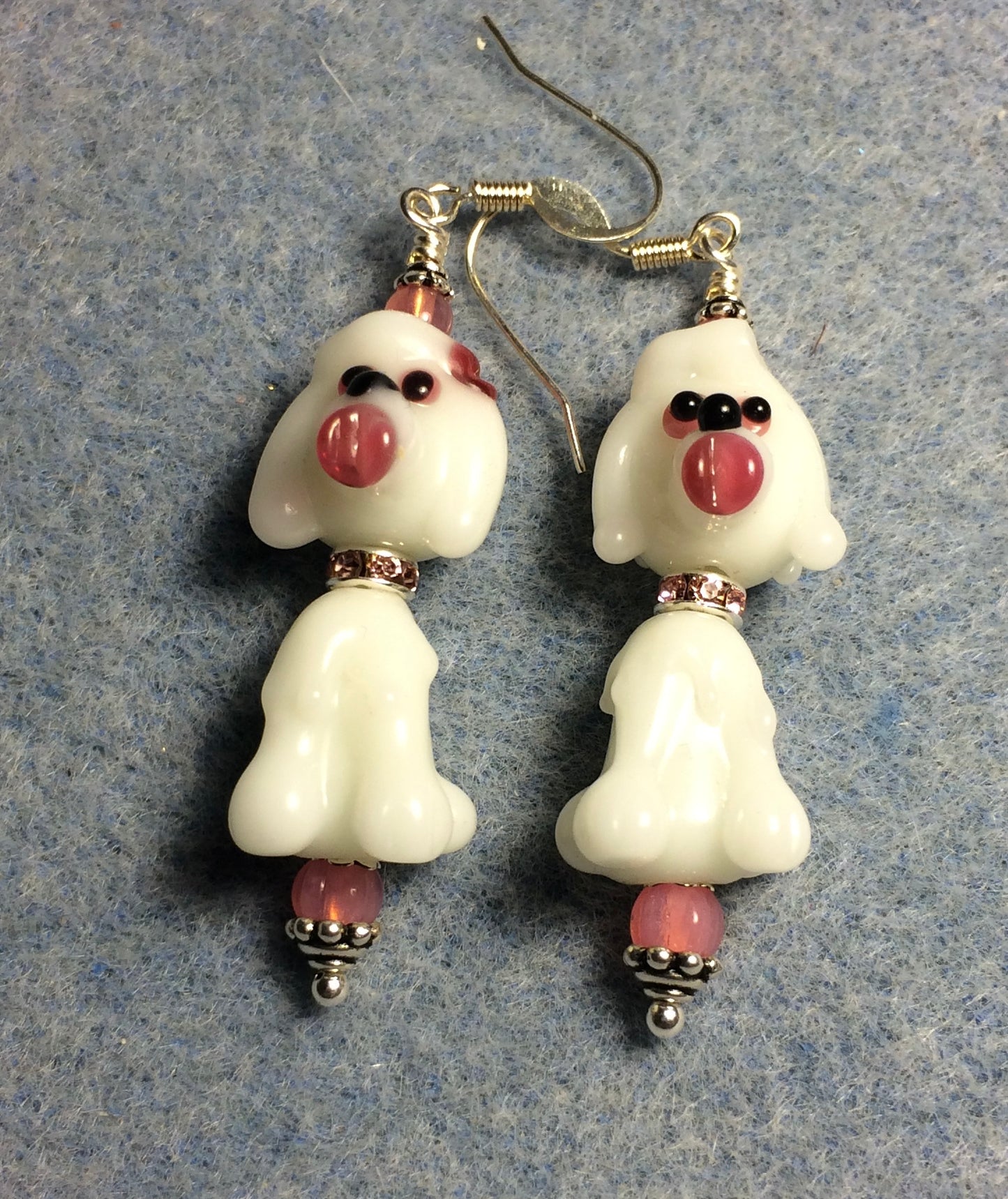 White and pink lamp work poodle bead earrings adorned with pink rhinestone rondelle “collars” and pink Czech glass beads.