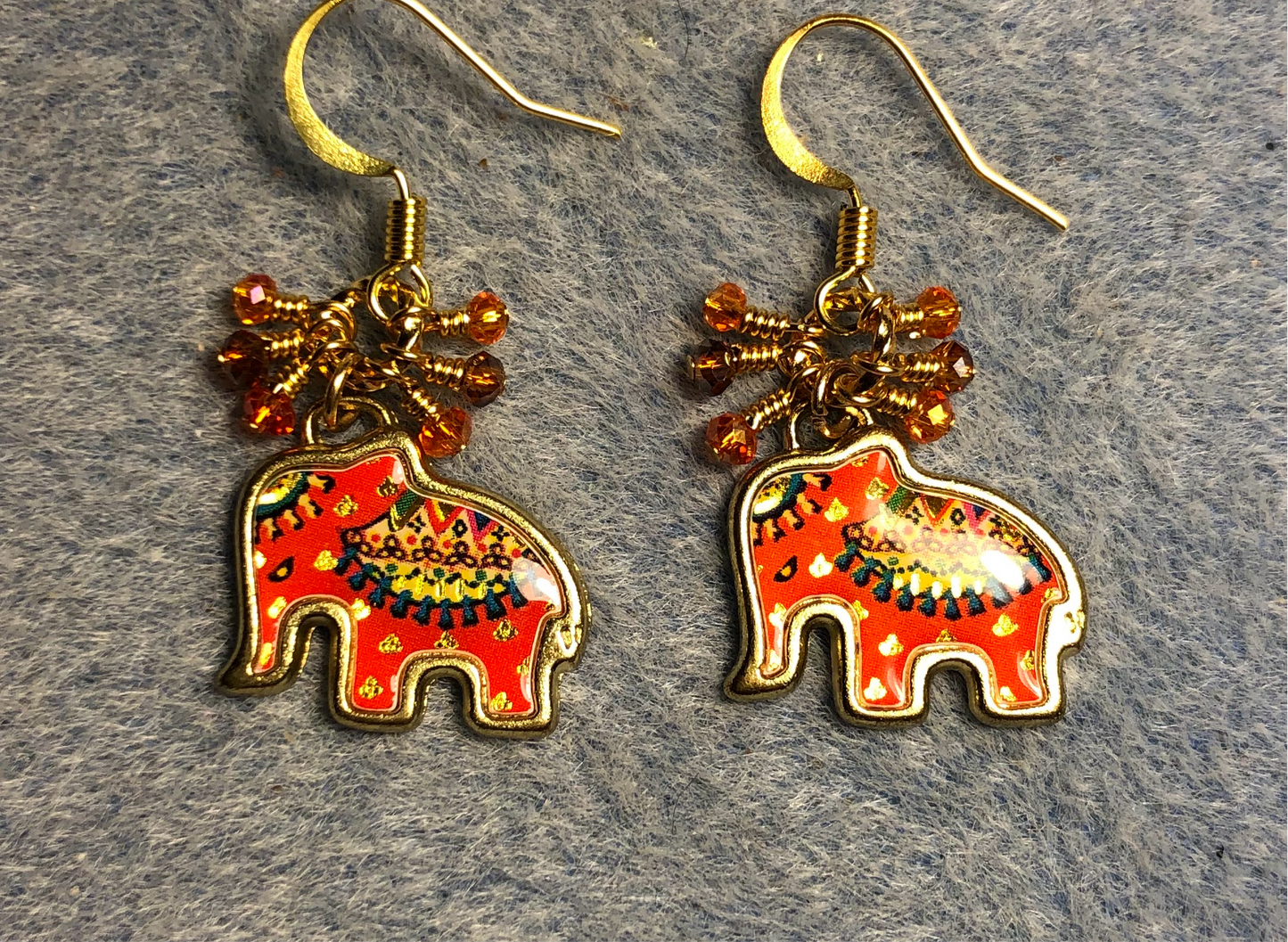 Orange and amber enamel elephant charm earrings adorned with tiny dangling orange and amber Chinese crystal beads.