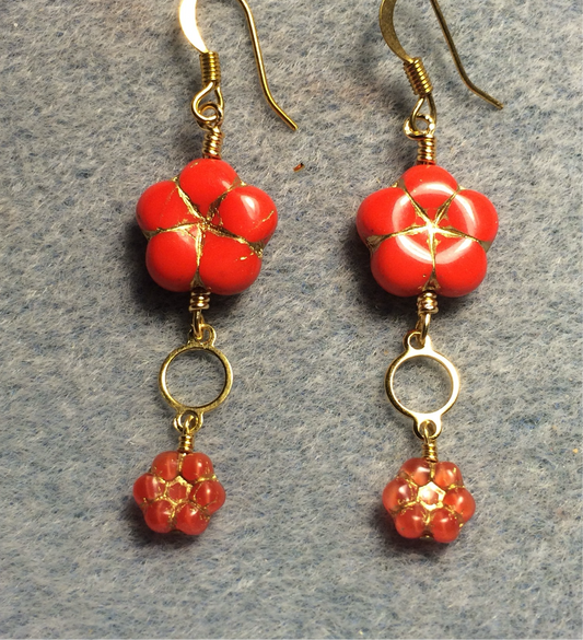 Bright red Czech glass puffy flower bead earrings adorned with gold circle connectors and small bright red Czech glass daisy beads.