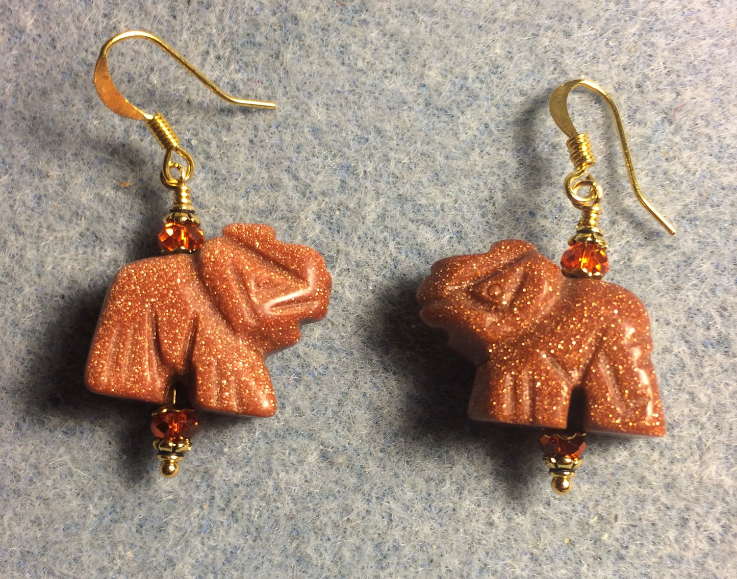 Orange goldstone gemstone elephant bead earrings adorned with orange Chinese crystal beads.