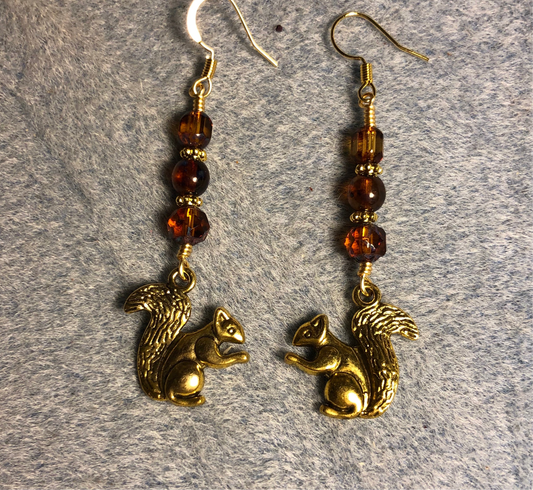 Gold squirrel charm earrings adorned with brown Czech glass beads