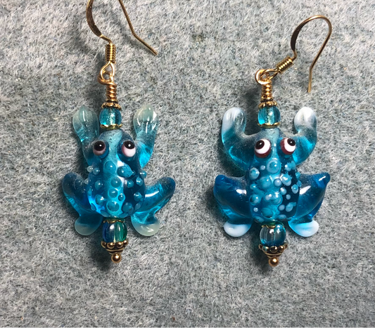 Turquoise and white lamp work spotted frog bead earrings adorned with turquoise Czech glass beads.