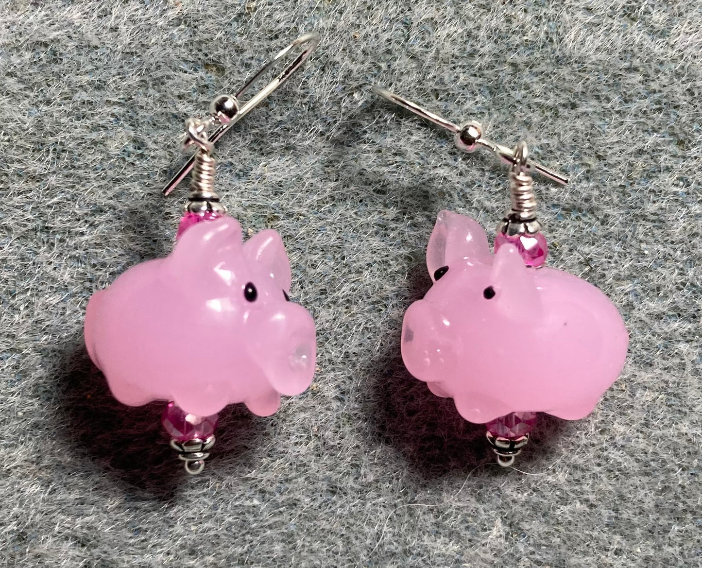 Light pink lamp work pig bead earrings adorned with hot pink Chinese crystal beads.