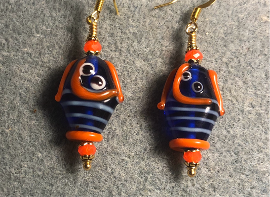 Dark blue and orange lamp work fish bead earrings adorned with orange Chinese crystal beads.