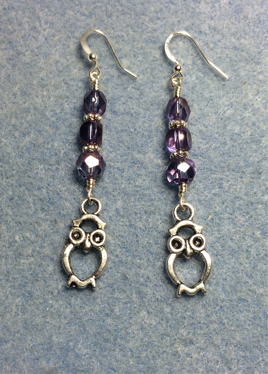 Silver owl charm earrings adorned with purple Czech glass beads.