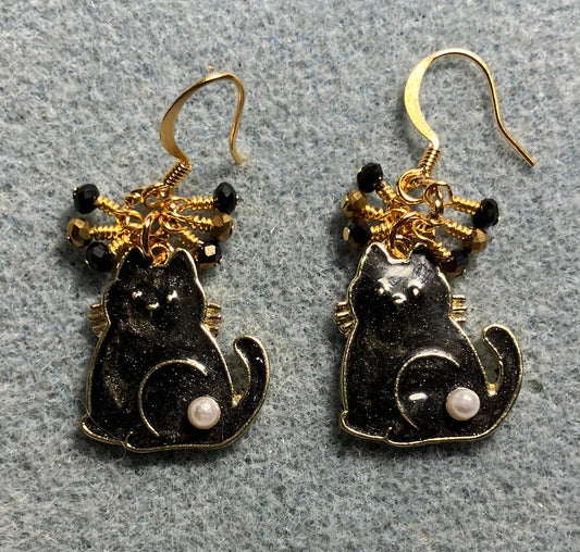 Black and gold enamel and pearl cat charm earrings adorned with tiny dangling black and gold Chinese crystal beads.