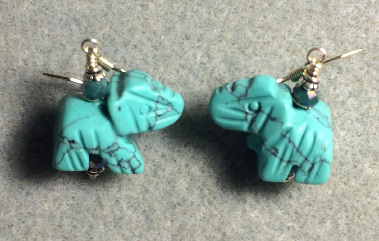 Turquoise howlite gemstone elephant bead earrings adorned with turquoise Chinese crystal beads.