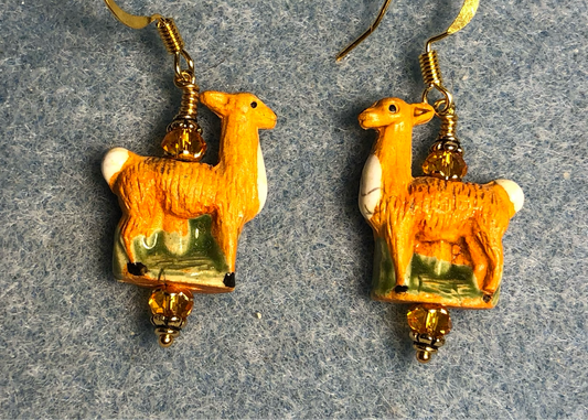 Small tangerine ceramic llama bead earrings adorned with tangerine Chinese crystal beads.