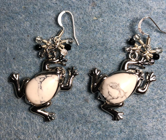 Large silver and white howlite gemstone frog charm earrings adorned with small dangling silver, black, and clear Czech glass beads.