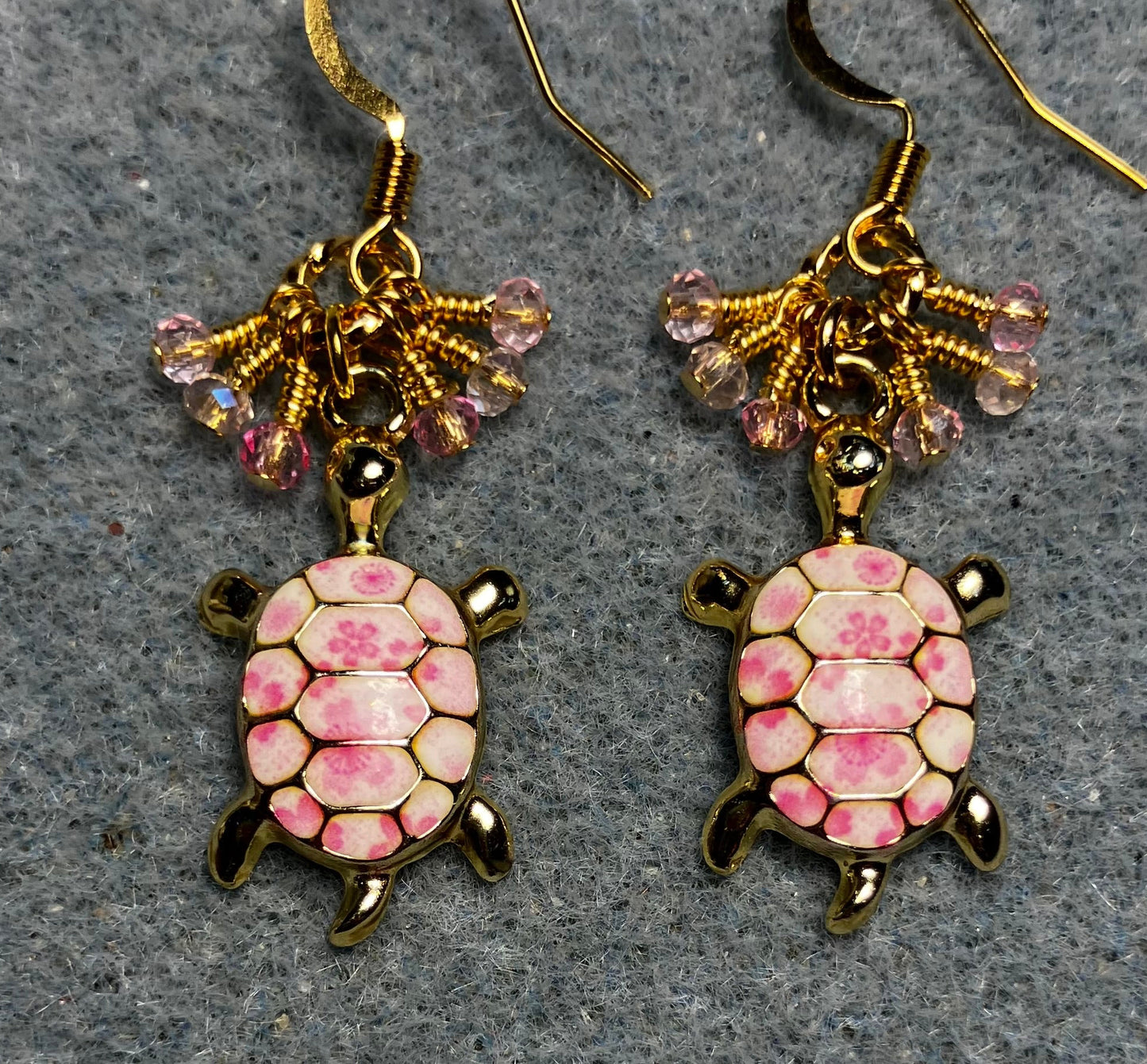 Pink and white enamel turtle charm earrings adorned with tiny dangling pink Chinese crystal beads.