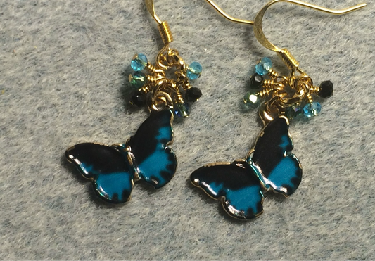 Dark turquoise and black enamel butterfly charm earrings adorned with tiny dangling turquoise and black Chinese crystal beads.