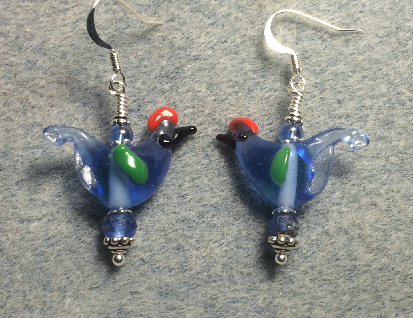 Translucent light blue red crested lamp work songbird bead earrings adorned with light blue Czech glass beads.