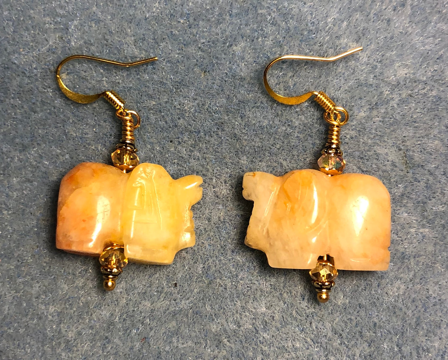 Yellow jadeite gemstone elephant bead earrings adorned with amber Chinese crystal beads.