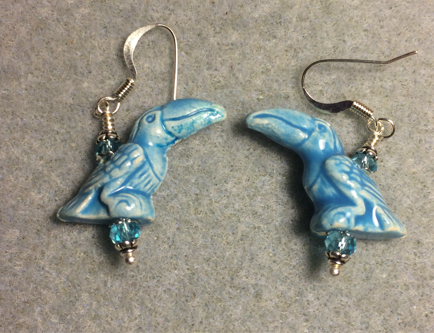 Turquoise ceramic toucan bead earrings adorned with turquoise Chinese crystal beads.