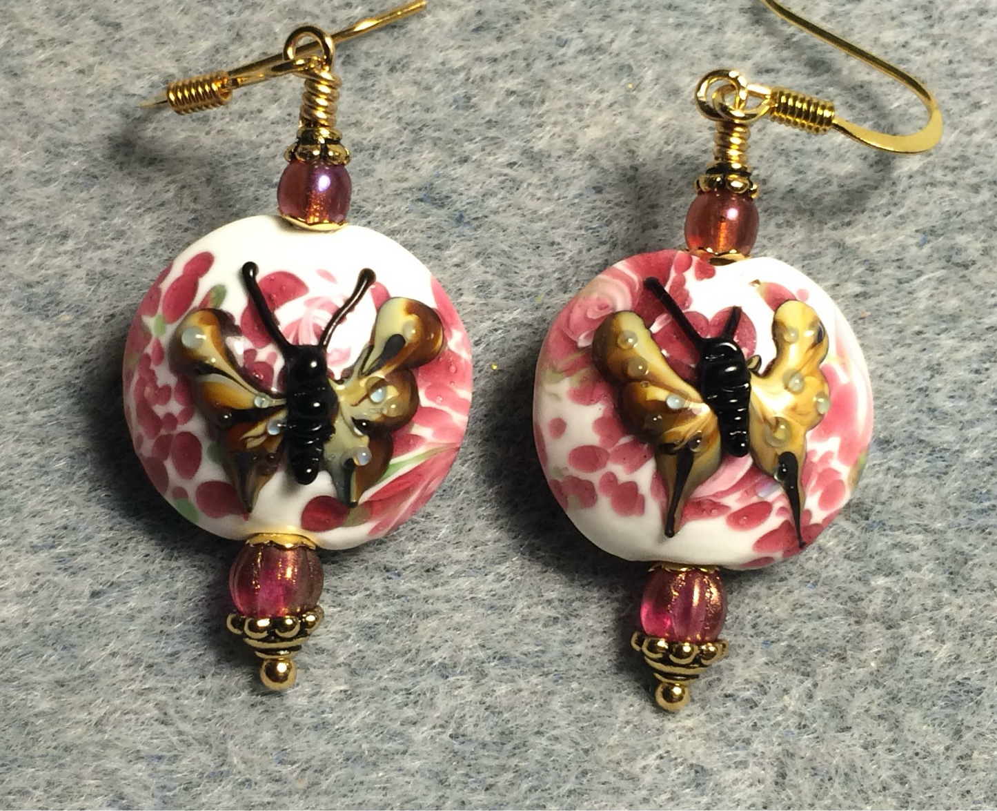 Bright pink and tan lamp work butterfly bead earrings adorned with bright pink Czech glass beads.