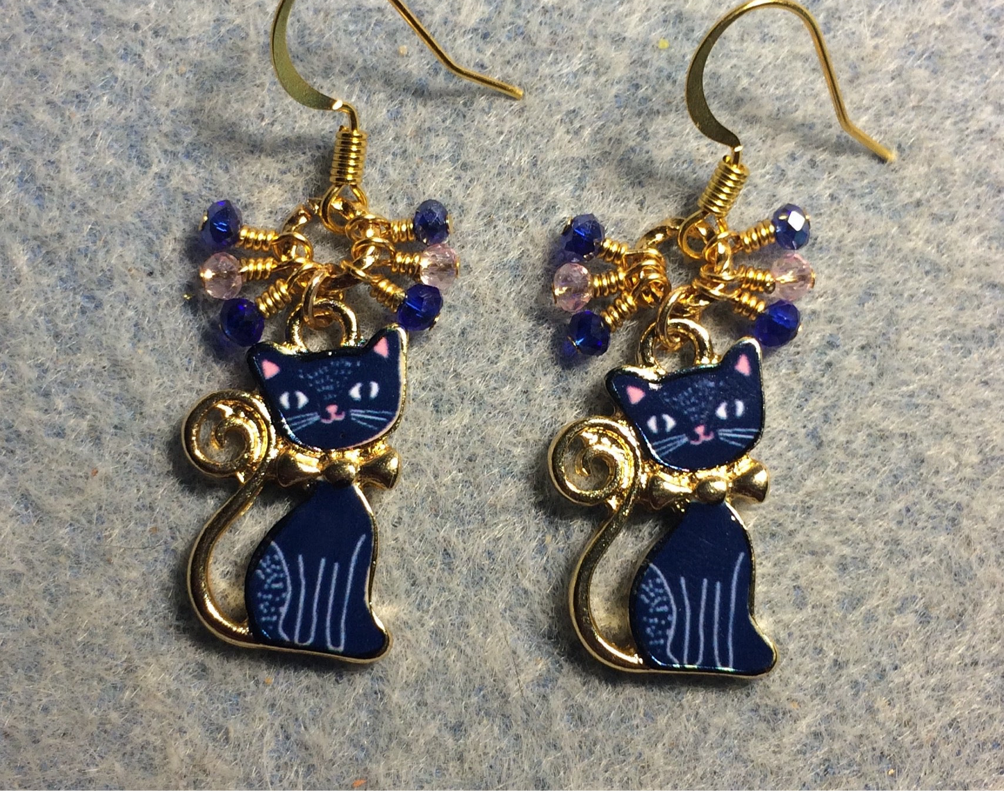 Dark blue and pink enamel cat charm earrings adorned with small dangling dark blue and pink Chinese crystal beads.