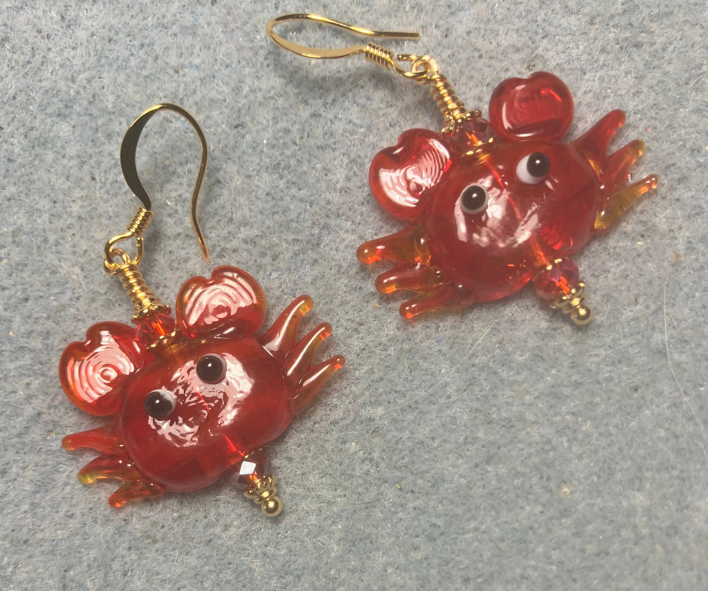 Red lamp work crab bead earrings adorned with red Chinese crystal beads.