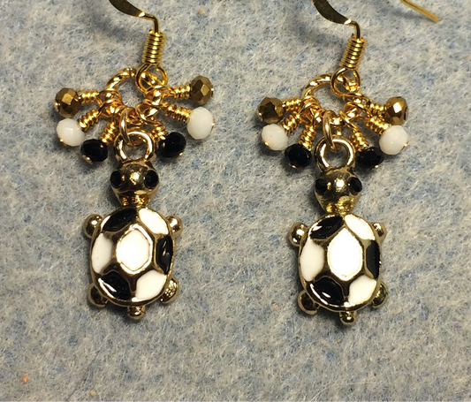 Small black, white, and gold enamel turtle charm earrings adorned with tiny dangling black, white, and gold Chinese crystal beads.