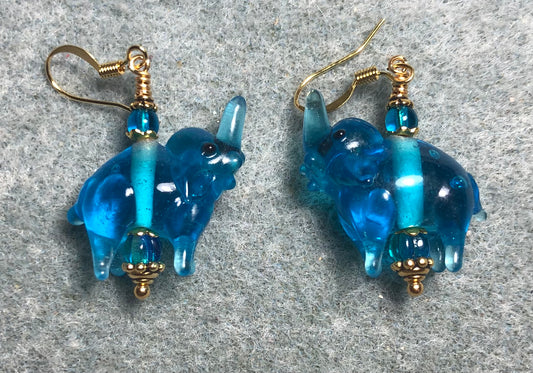 Translucent turquoise lamp work elephant bead earrings adorned with turquoise Czech glass beads.