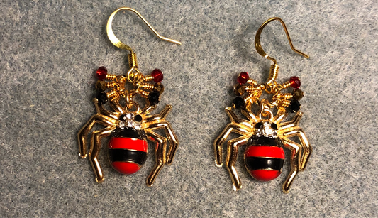 Black and red enamel striped spider charm earrings adorned with tiny dangling black, gold, and red Chinese crystal beads.