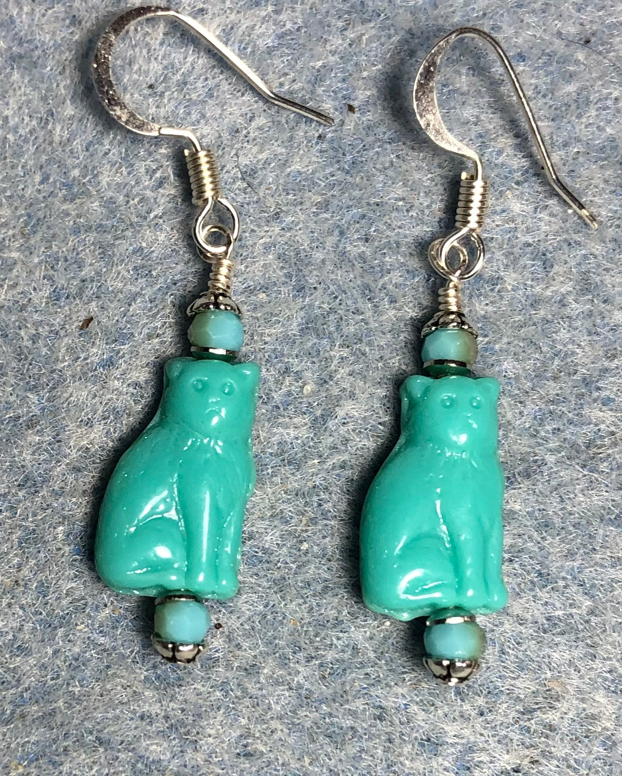 Small opaque turquoise Czech glass cat bead earrings adorned with turquoise Chinese crystal beads.
