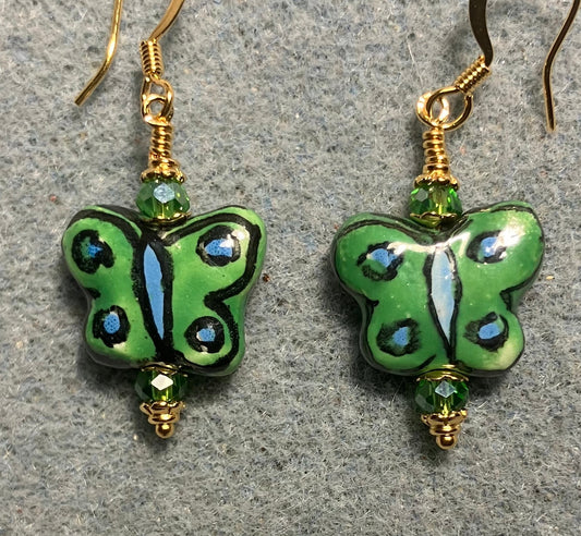 Green, black, and light blue ceramic butterfly bead earrings adorned with green Chinese crystal beads.