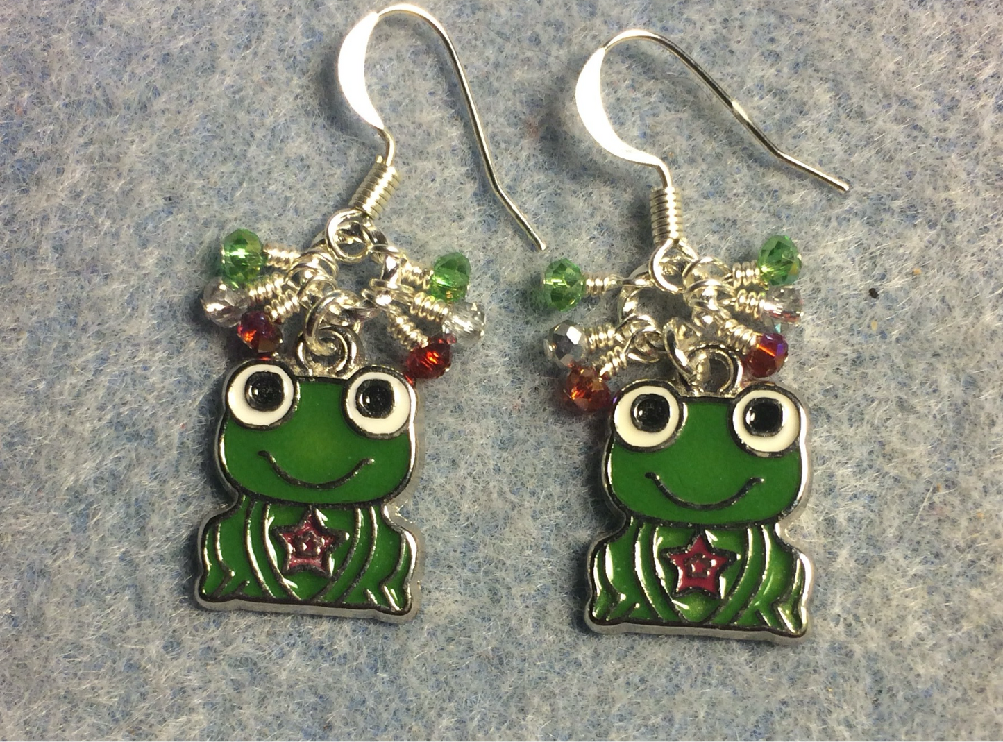 Green, white, and red enamel  frog prince charm earrings adorned with tiny dangling green, silver, and red Chinese crystal beads.