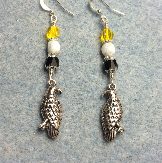 Silver eagle charm earrings adorned with black, white, and yellow Czech glass beads