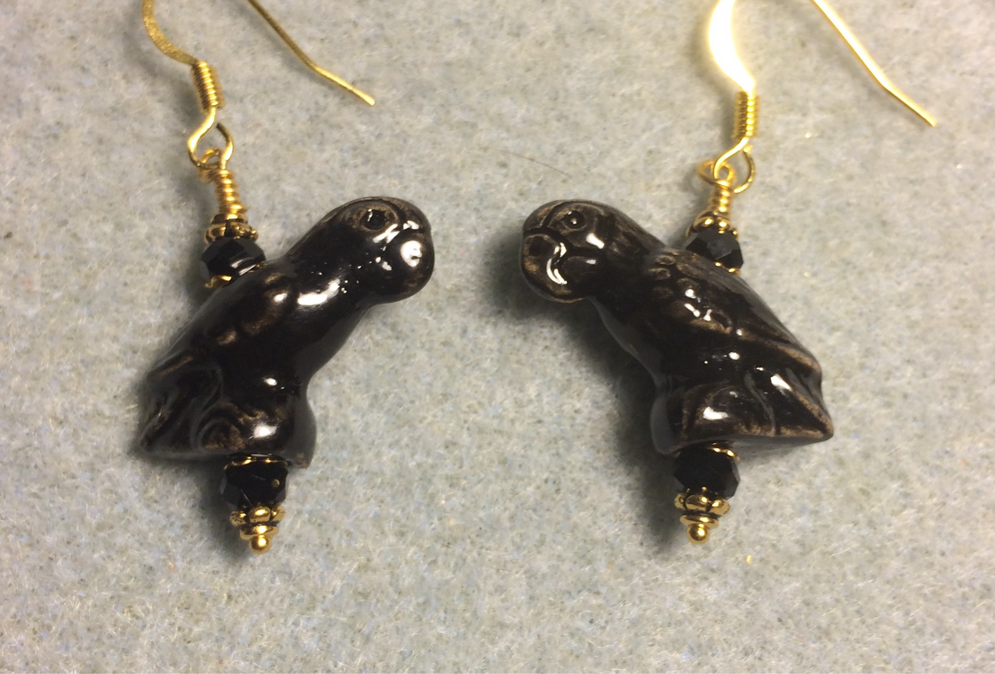 Black ceramic parrot bead earrings adorned with black Chinese crystal beads.