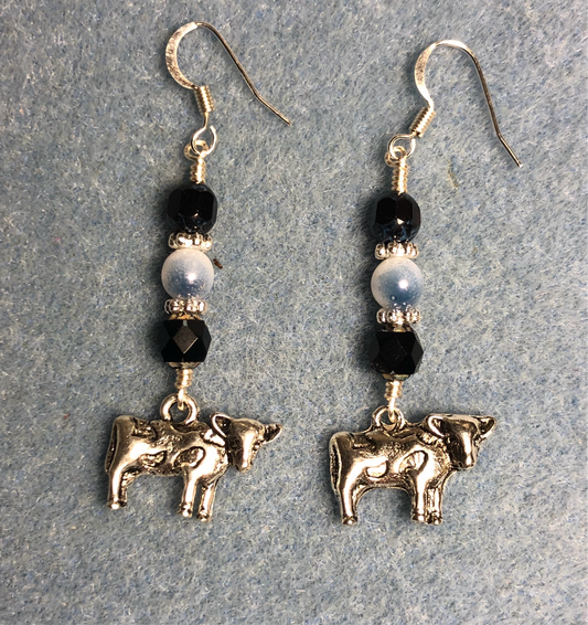 Silver cow charm earrings adorned with black and white Czech glass beads