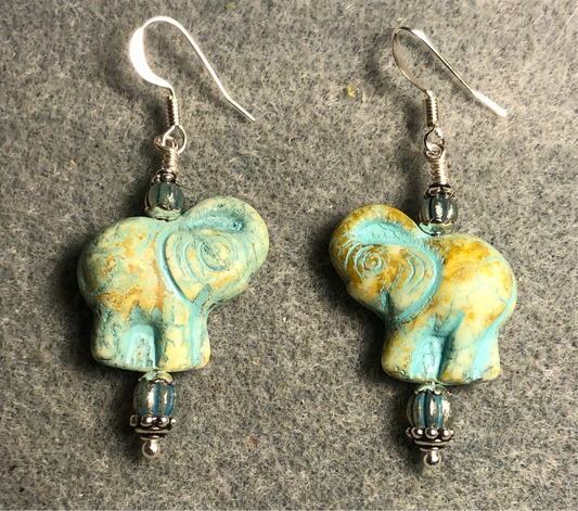 Beige (with turquoise inlay) Czech glass elephant bead earrings adorned with turquoise Czech glass beads.