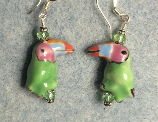 Light green ceramic toucan bead earrings adorned with light green Chinese crystal beads.