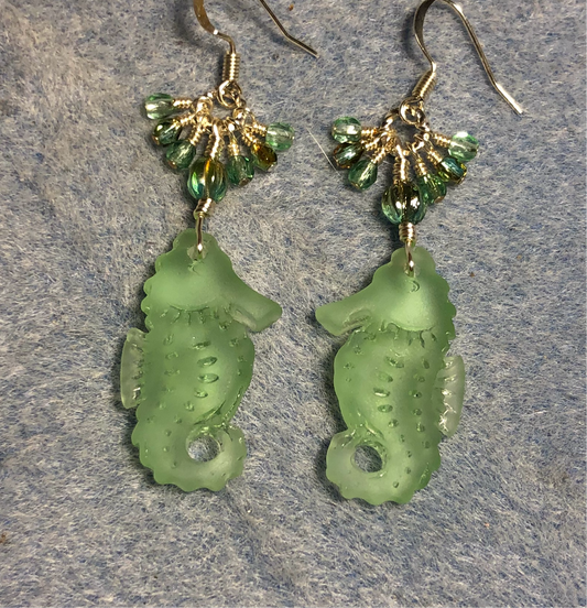 Light green sea glass seahorse pendant bead earrings adorned with light green Czech glass beads and small dangling light green Czech glass beads.