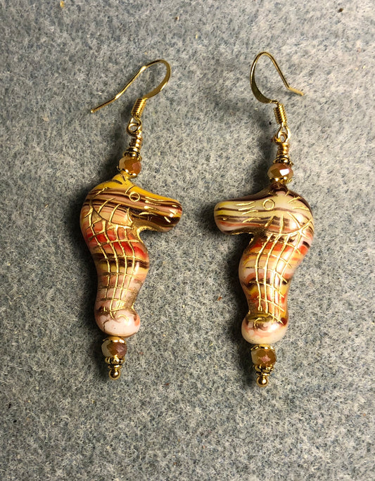 Tan, brown, and orange striped Czech glass seahorse bead earrings adorned with tan Chinese crystal beads.