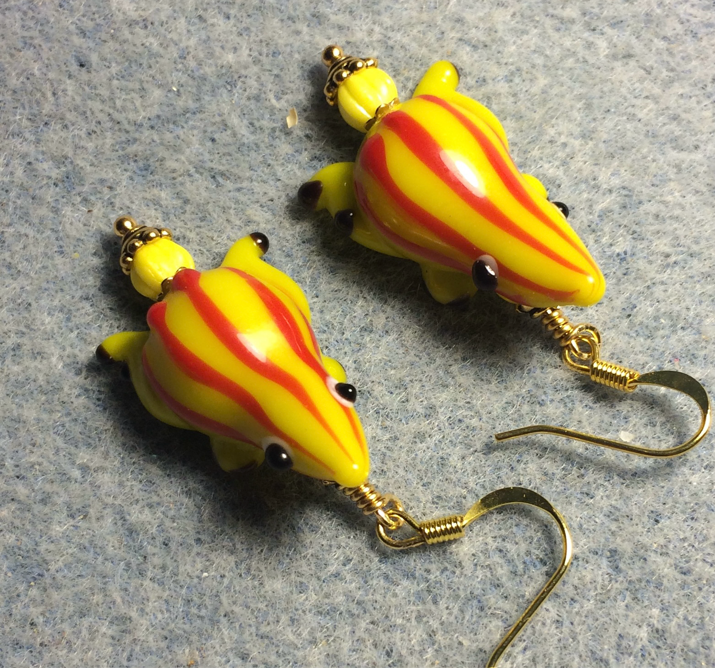 Yellow with red stripes lamp work frog bead earrings adorned with yellow Czech glass beads.