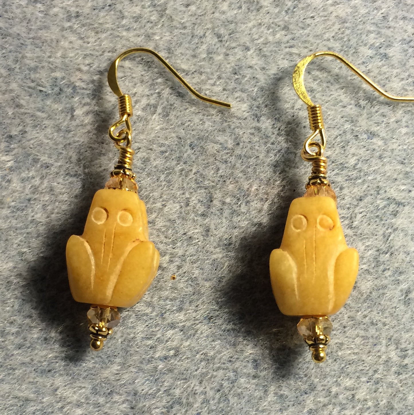 Carved yellow jade gemstone frog bead earrings adorned with amber Chinese crystal beads.