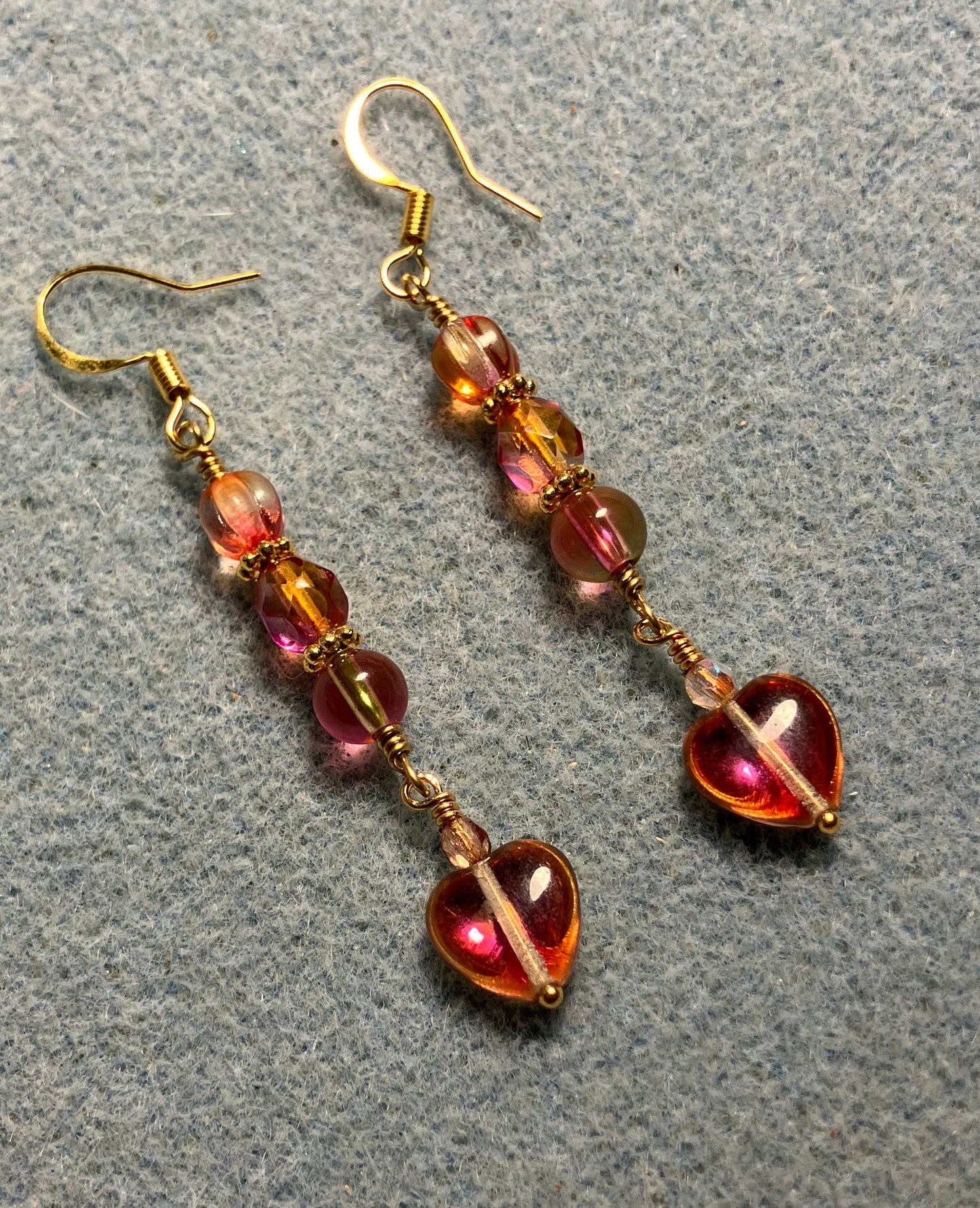 Small pinkish orange Czech glass heart bead earrings adorned with pinkish orange Czech glass beads.