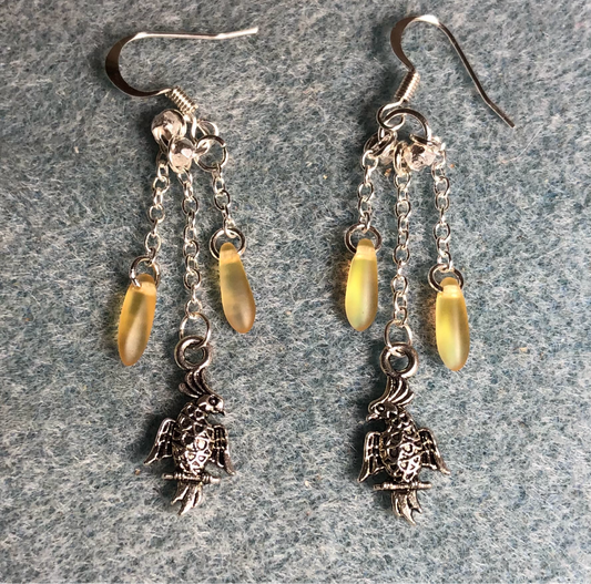 Small silver cockatoo charm earrings attached to silver chain and adorned with small yellow Czech glass dagger beads