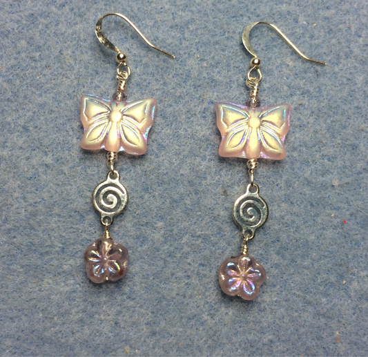 Light pink Czech glass butterfly bead earrings adorned with silver swirly connectors and light pink Czech glass daisy beads.