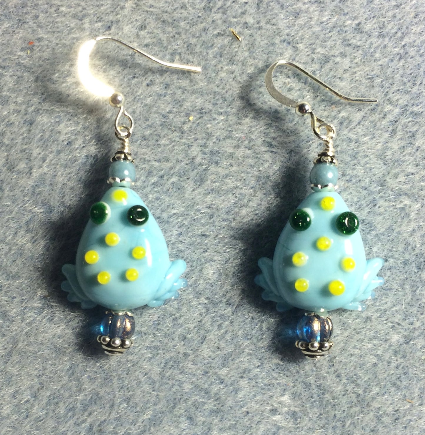 Opaque light blue lamp work frog bead earrings adorned with light blue Czech glass beads.