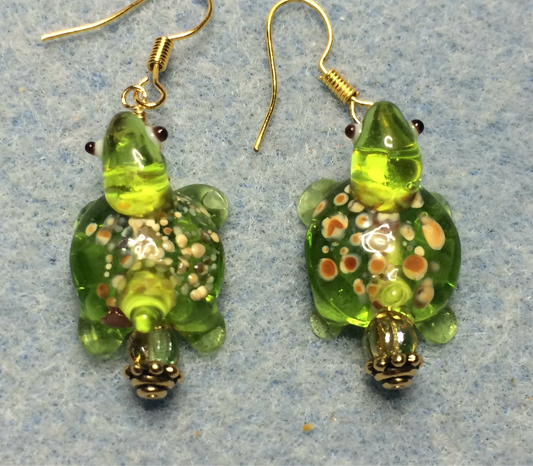 Translucent lime green lamp work spotted turtle bead earrings adorned with lime green Czech glass beads.