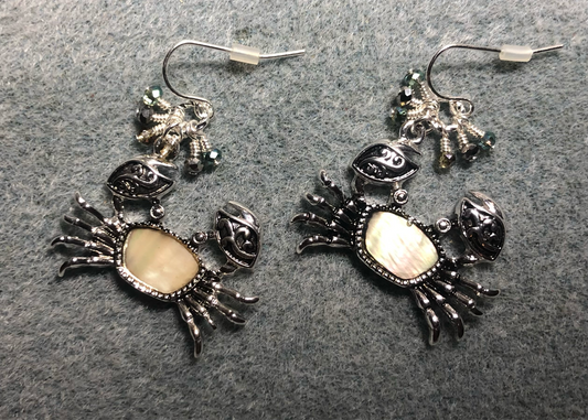 Silver and mother of pearl crab charm earrings adorned with tiny dangling silver and green Chinese crystal beads.