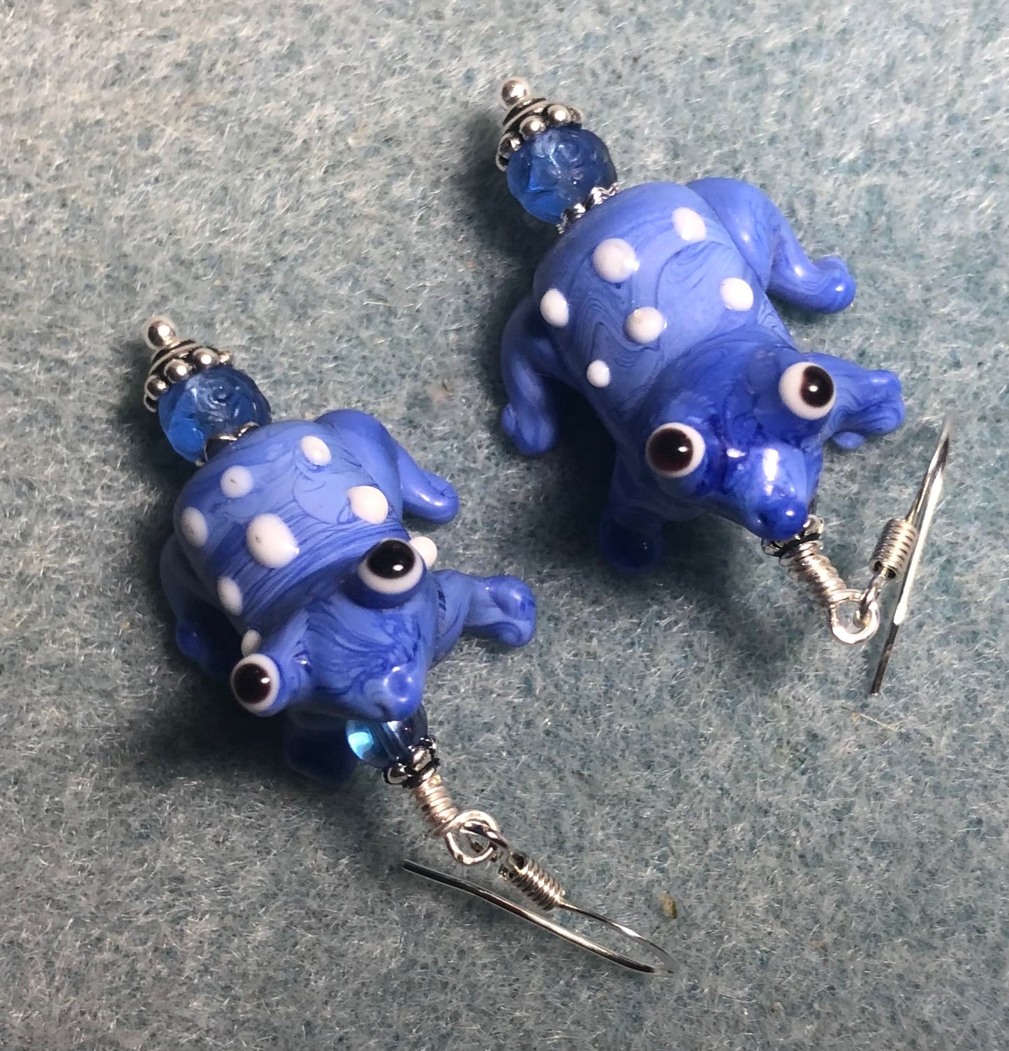 Blue and white lamp work spotted frog bead earrings adorned with blue Czech glass beads.