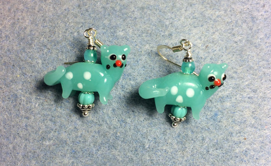 Opaque turquoise lamp work spotted cat bead earrings adorned with opaque turquoise Czech glass beads.