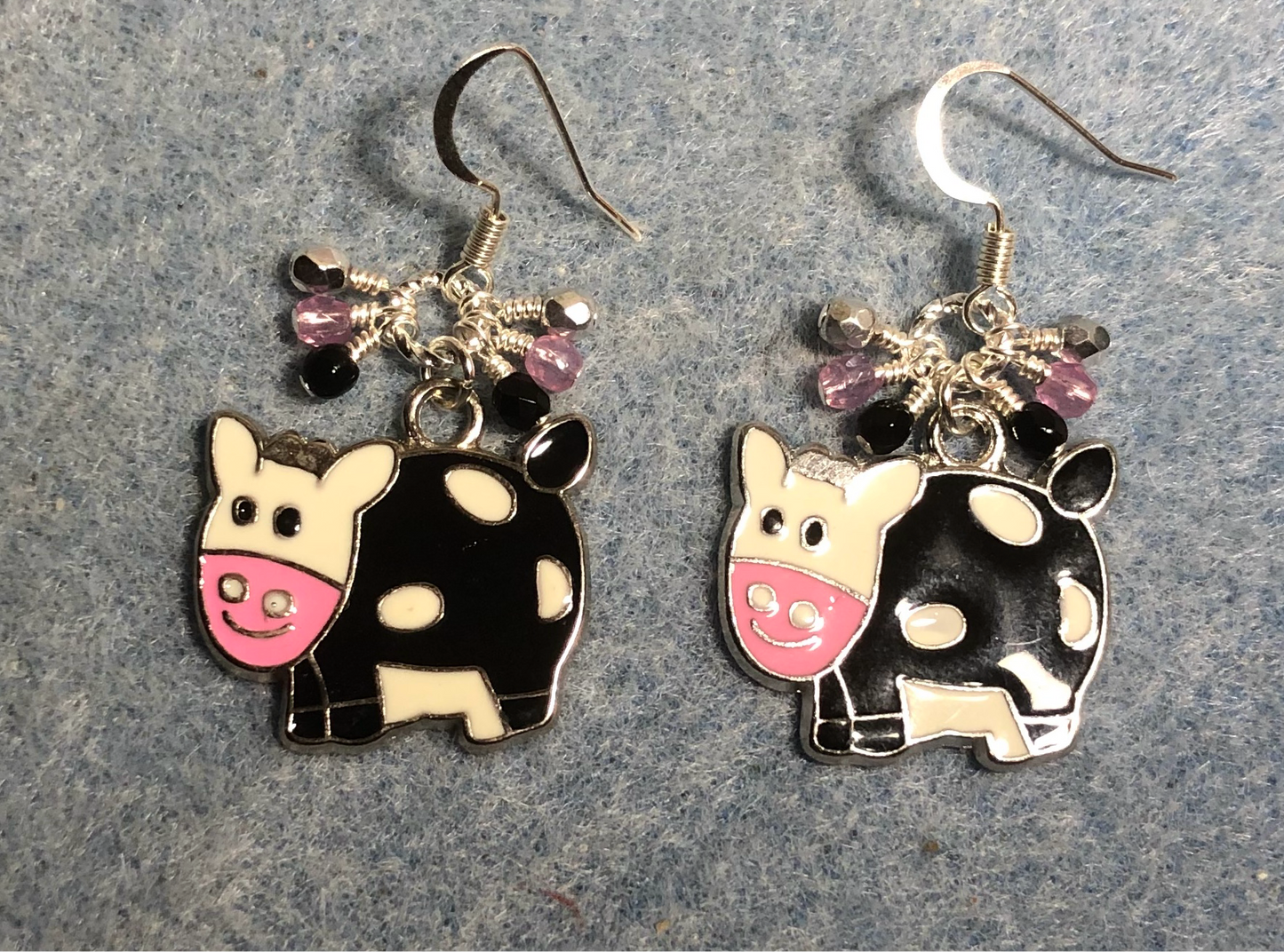 Black, white, and pink enamel pig charm earrings adorned with tiny dangling black, pink, and silver Czech glass beads.