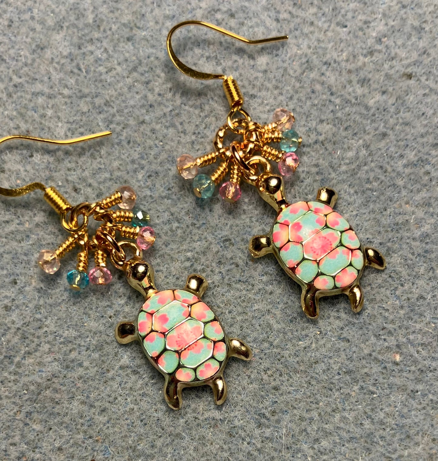 Pink and turquoise enamel turtle charm earrings adorned with tiny dangling pink and turquoise Chinese crystal beads.